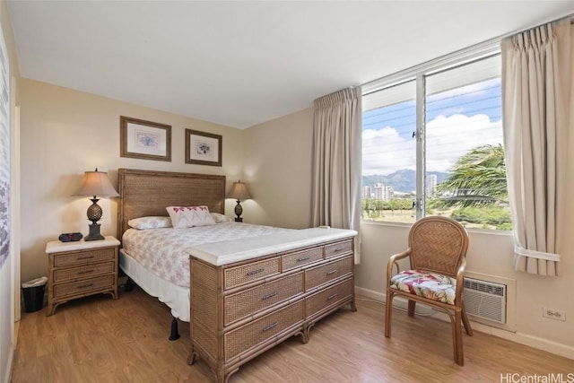 bedroom with light wood-type flooring and baseboards