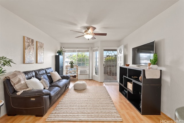 living area with light wood-type flooring and ceiling fan