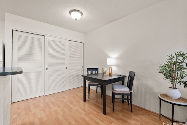 office with wood finished floors and a textured ceiling