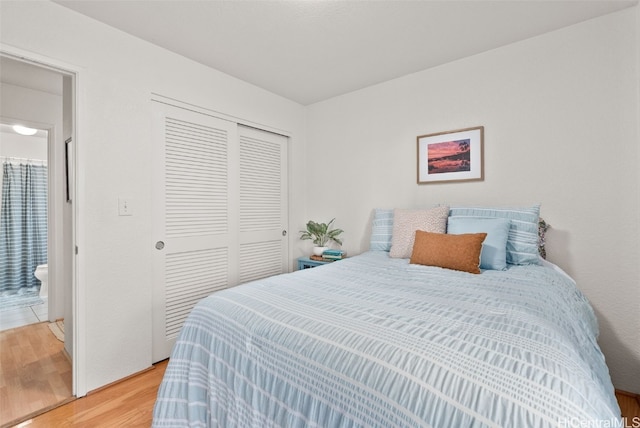 bedroom featuring light wood-style flooring and a closet