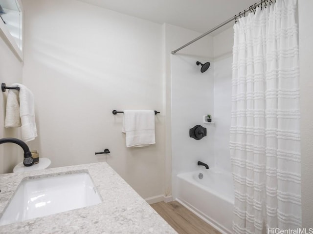 full bathroom featuring wood finished floors, vanity, and shower / bath combination with curtain