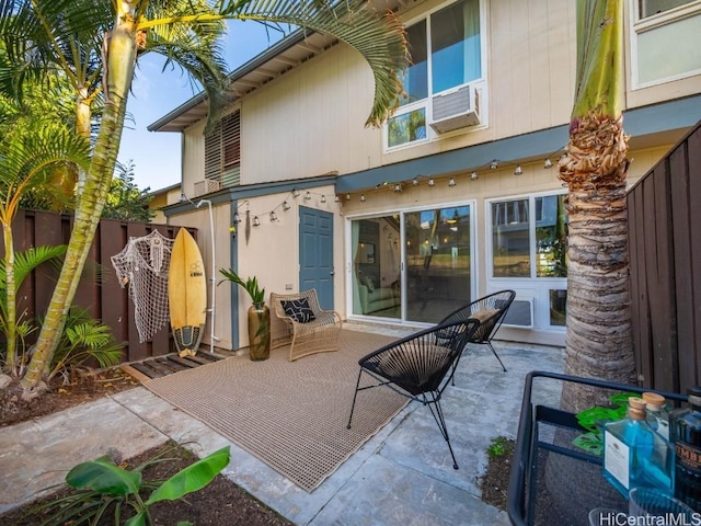 view of patio featuring cooling unit and fence