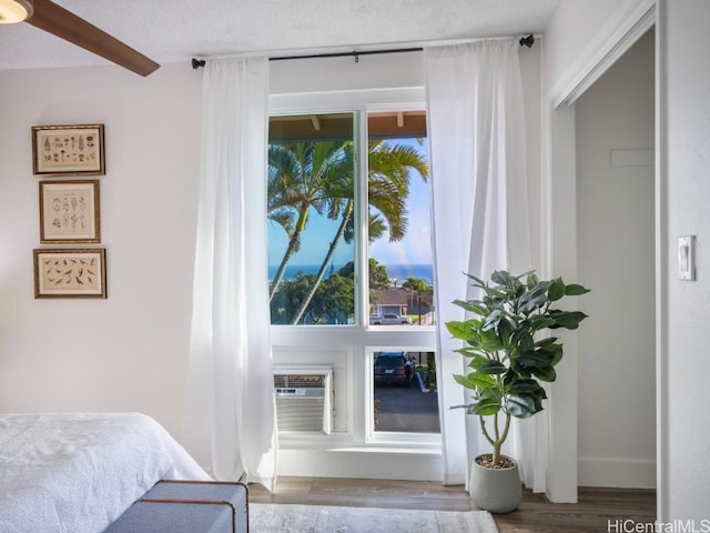 bedroom featuring baseboards and wood finished floors