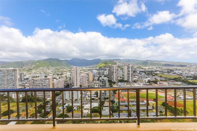 balcony with a mountain view and a city view