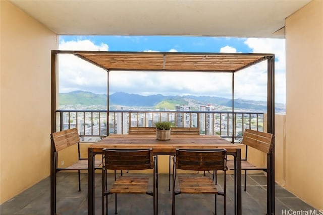 balcony with outdoor dining area and a mountain view