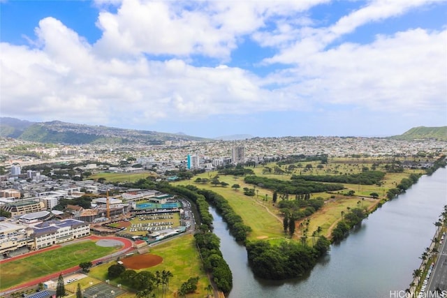 drone / aerial view featuring a city view and a water view