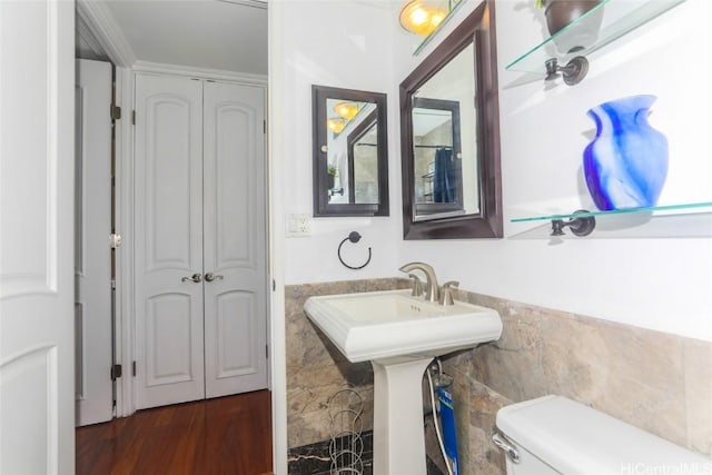 bathroom with tile walls and toilet