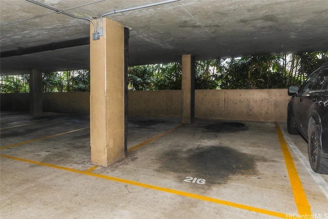 view of vehicle parking with a parking garage