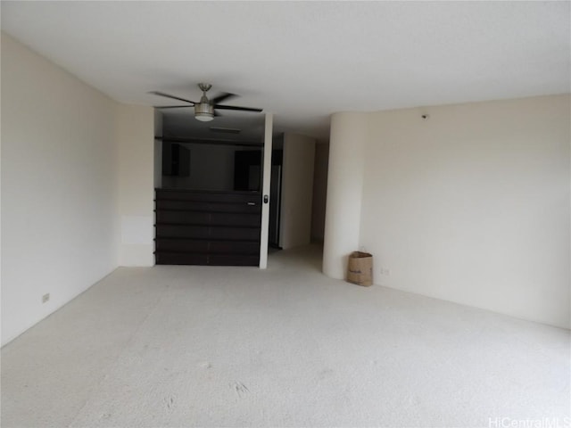 spare room with carpet flooring and a ceiling fan