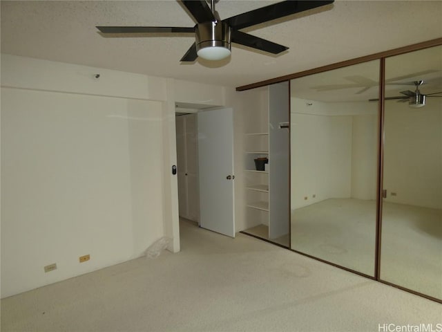 unfurnished bedroom featuring a textured ceiling, a ceiling fan, and carpet floors