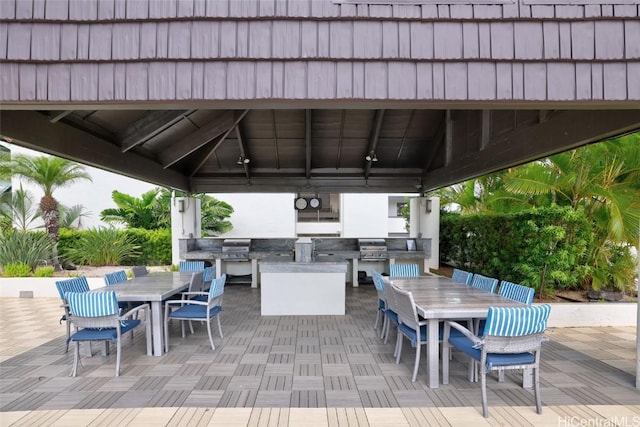 view of patio featuring a gazebo, area for grilling, outdoor dining space, and a grill