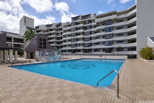 community pool featuring a patio and fence