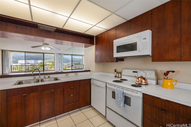 kitchen with visible vents, a sink, white appliances, light countertops, and ceiling fan