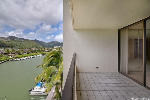 balcony featuring a water and mountain view