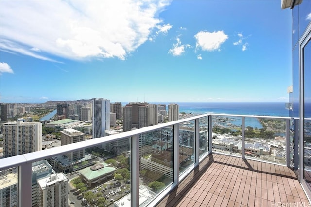 balcony featuring a view of city and a water view