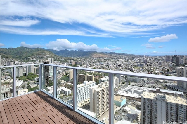 balcony featuring a city view and a mountain view