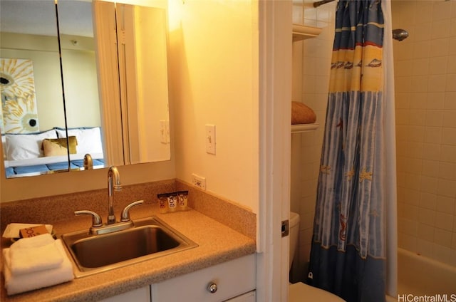 bathroom featuring shower / bathtub combination with curtain, toilet, and vanity