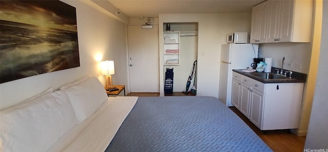 2463 Kuhio Ave Unit 510, Honolulu, HI 96815 - bedroom with freestanding refrigerator, a sink, and dark wood-style flooring