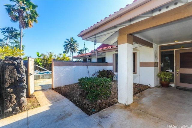 view of property exterior featuring stucco siding and fence