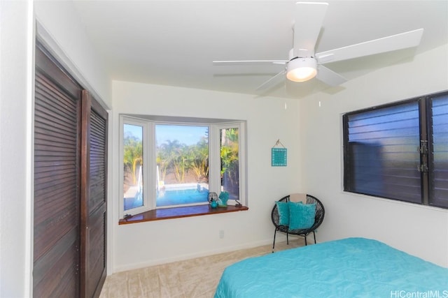 bedroom with baseboards, a closet, carpet floors, and a ceiling fan