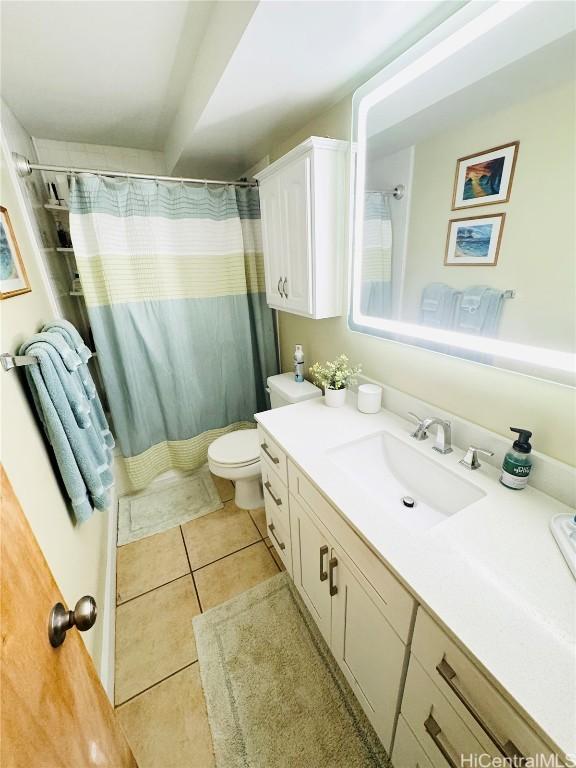 bathroom with tile patterned floors, a shower with shower curtain, toilet, and vanity