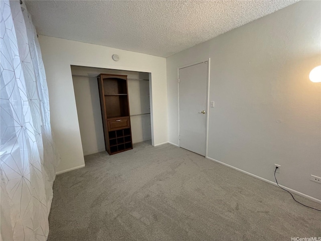 46-232 Kahuhipa St Unit B207, Kaneohe, HI 96744 - unfurnished bedroom featuring carpet, a textured ceiling, a closet, and baseboards