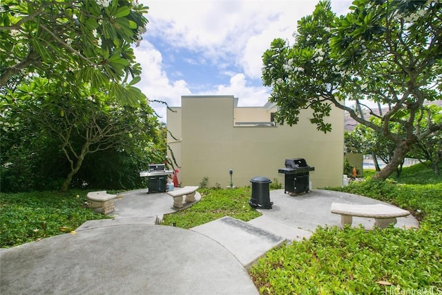 view of home's exterior with stucco siding and a patio