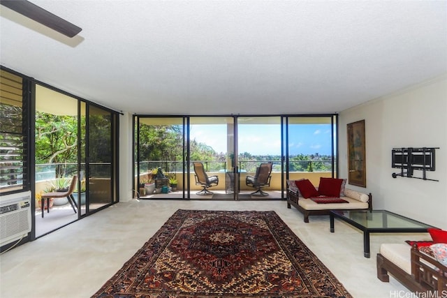 carpeted living area featuring a wall of windows and a textured ceiling