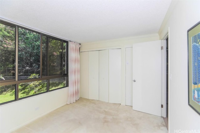 unfurnished bedroom featuring carpet flooring and a textured ceiling