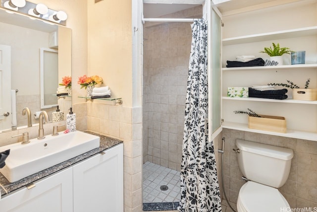 3061 Pualei Cir Unit 303, Honolulu, HI 96815 - bathroom featuring tile walls, a tile shower, toilet, a wainscoted wall, and vanity