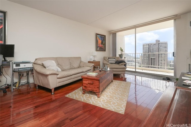 living area with expansive windows and wood finished floors