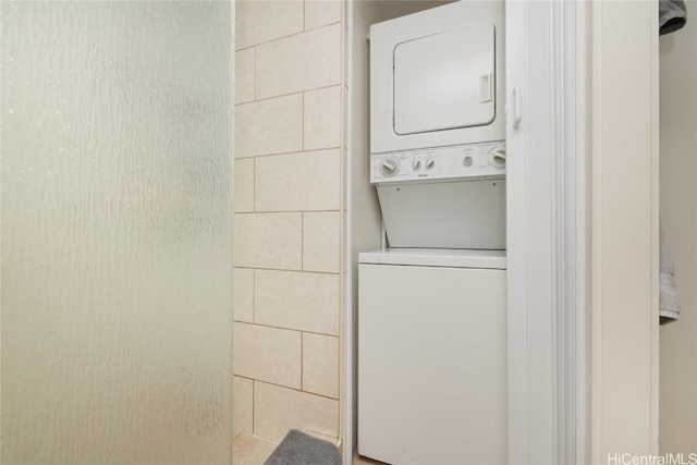 laundry area with laundry area and stacked washer / drying machine