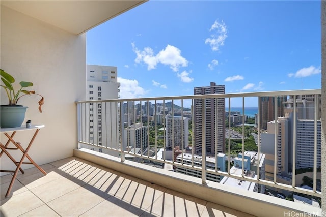 balcony with a water view and a city view