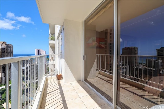 balcony featuring a view of city and a water view