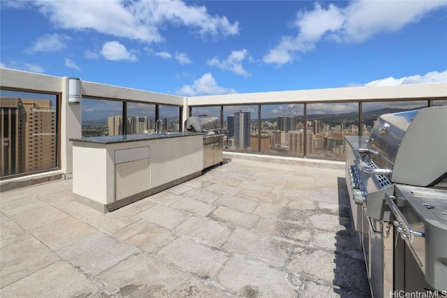 view of patio with grilling area and a balcony