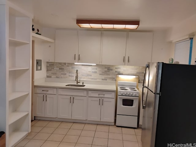 kitchen with white range with electric cooktop, a sink, open shelves, freestanding refrigerator, and light countertops