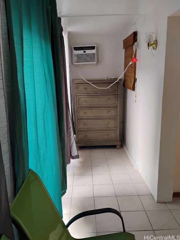 hallway with light tile patterned flooring and a wall mounted air conditioner