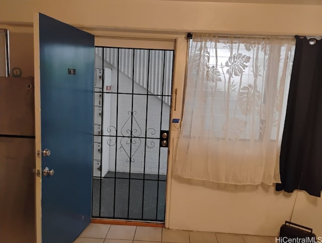 doorway with tile patterned flooring