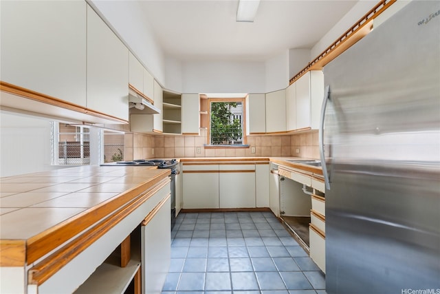 2712 Pulena Pl, Honolulu, HI 96822 - kitchen featuring freestanding refrigerator, open shelves, tile counters, decorative backsplash, and stove