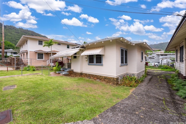 2712 Pulena Pl, Honolulu, HI 96822 - back of property with a mountain view and asphalt driveway