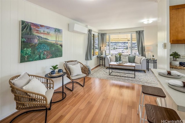 living room with light wood-style flooring and a wall mounted AC