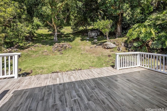 wooden terrace featuring a yard