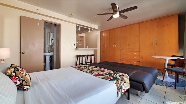 bedroom featuring tile patterned floors, a closet, and track lighting