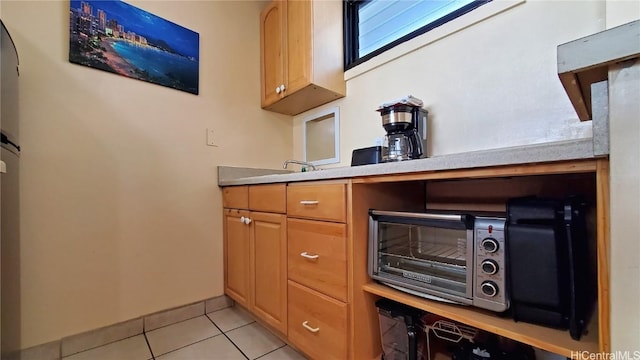 kitchen featuring light tile patterned flooring and light countertops