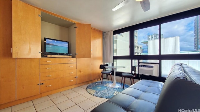 living room with a wealth of natural light, cooling unit, light tile patterned flooring, and ceiling fan