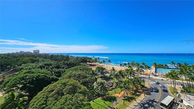 birds eye view of property with a water view and a beach view