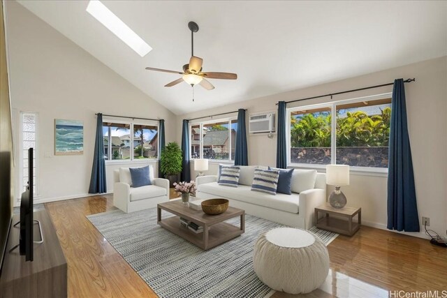 48 Kuuhale Pl, Kahului, HI 96732 - living room with high vaulted ceiling, an AC wall unit, a ceiling fan, wood finished floors, and a skylight
