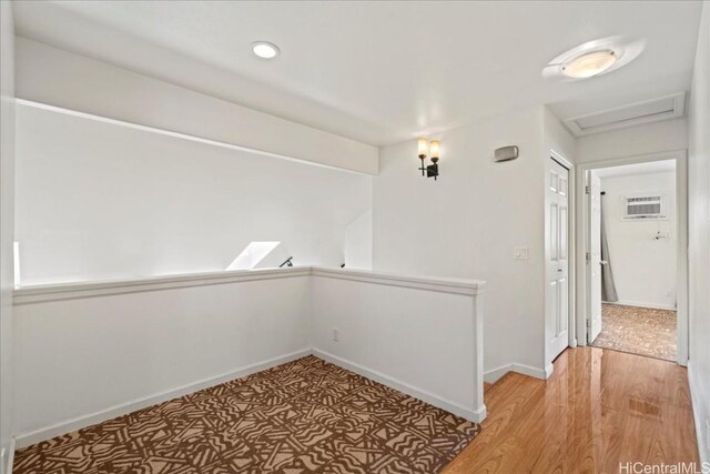 48 Kuuhale Pl, Kahului, HI 96732 - hallway with baseboards, attic access, light wood-type flooring, an upstairs landing, and a wall mounted AC