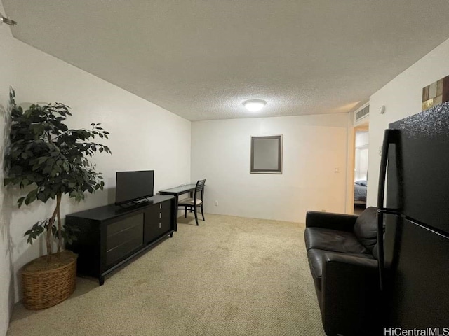 interior space with carpet, visible vents, and a textured ceiling