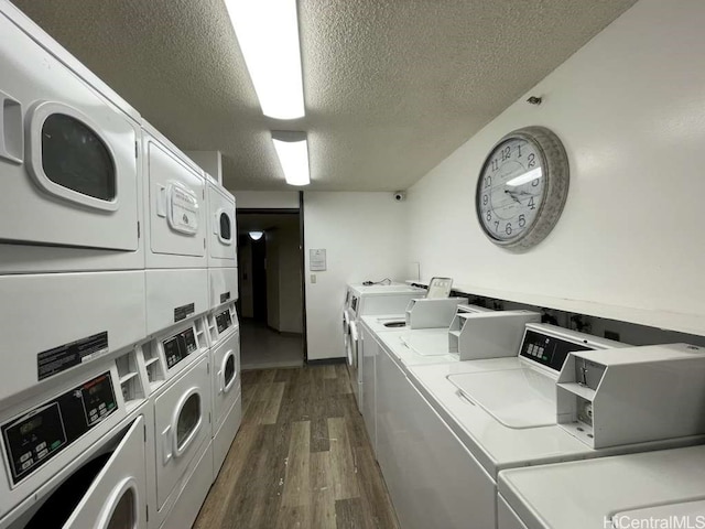 shared laundry area featuring washer and dryer, stacked washer and dryer, and dark wood finished floors